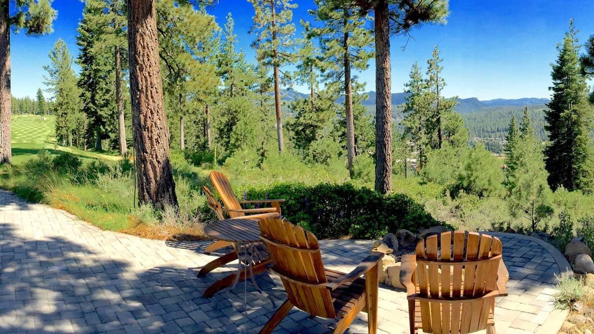 Adirondack chairs on clubhouse patio at Coyote Moon overlooking forest Adirondack chairs on clubhouse patio at Coyote Moon overlooking forest