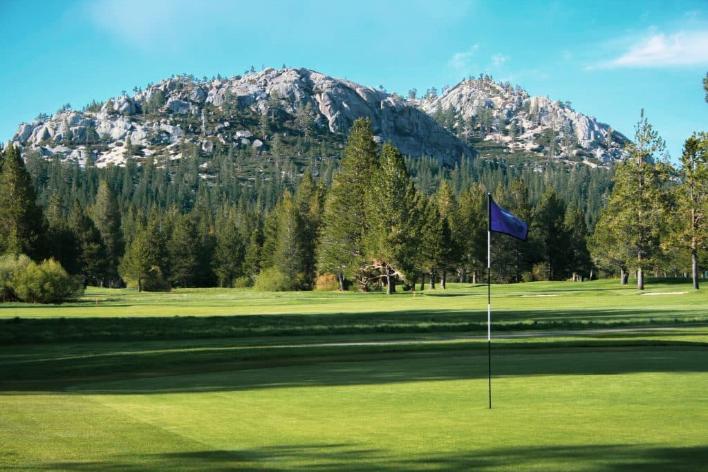 Hole 5 at Lake Tahoe Golf Course with pond and mountain view Hole 5 at Lake Tahoe Golf Course with pond and mountain view