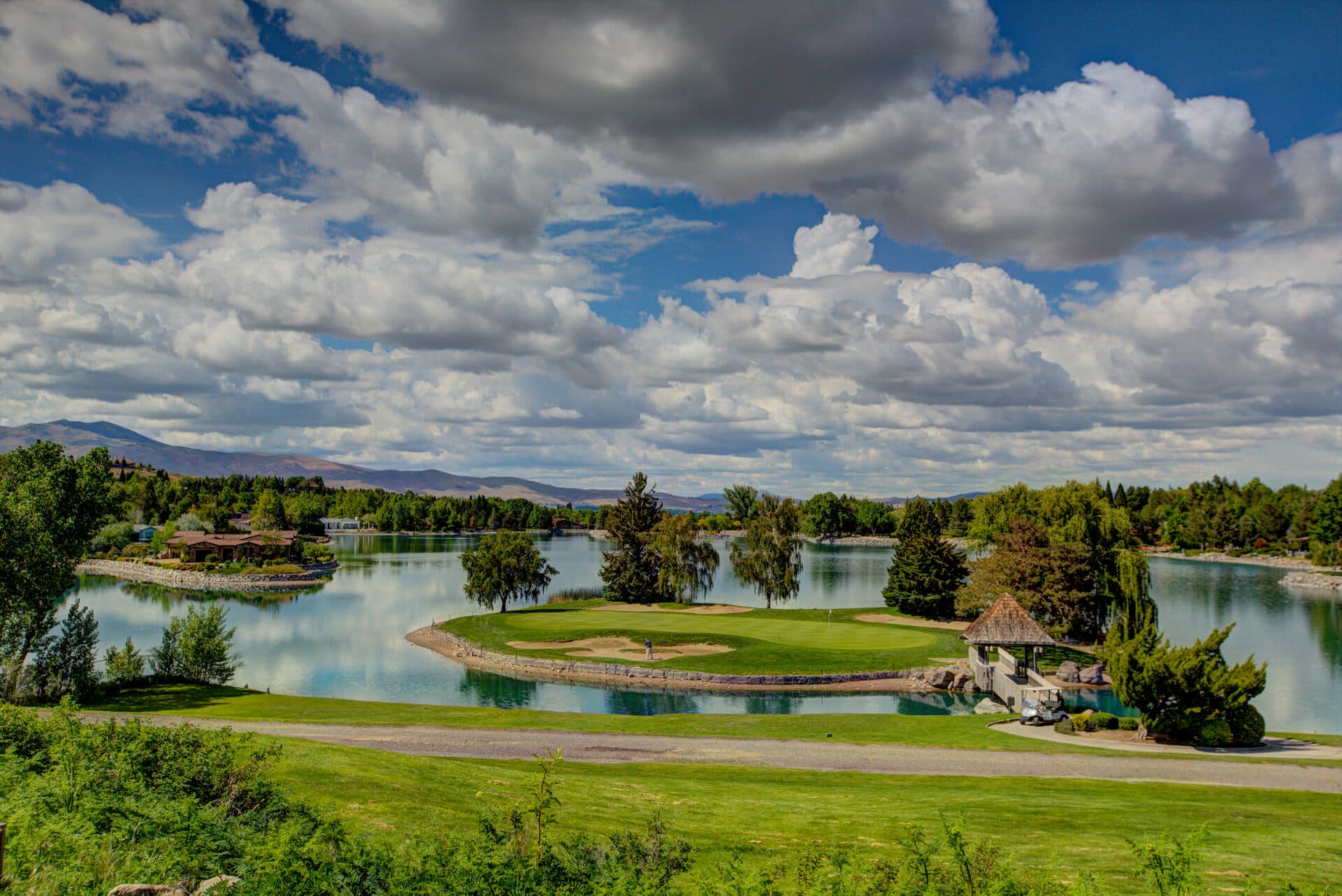 LakeRidge Golf Course panoramic island-green hole with lake reflections and Reno skyline LakeRidge Golf Course panoramic island-green hole with lake reflections and Reno skyline