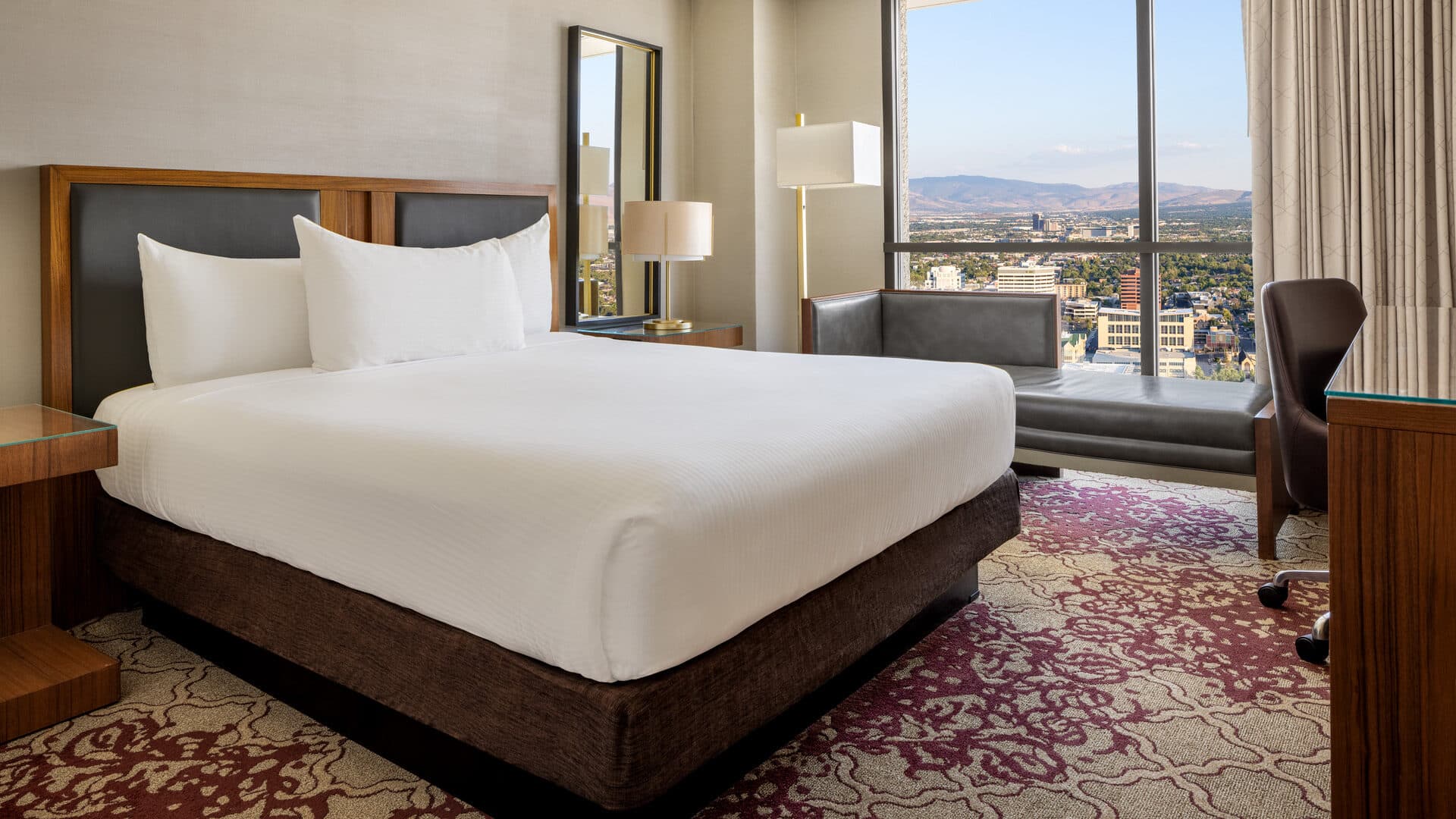 Eldorado Reno luxury king guest room with Reno city view through floor-to-ceiling windows