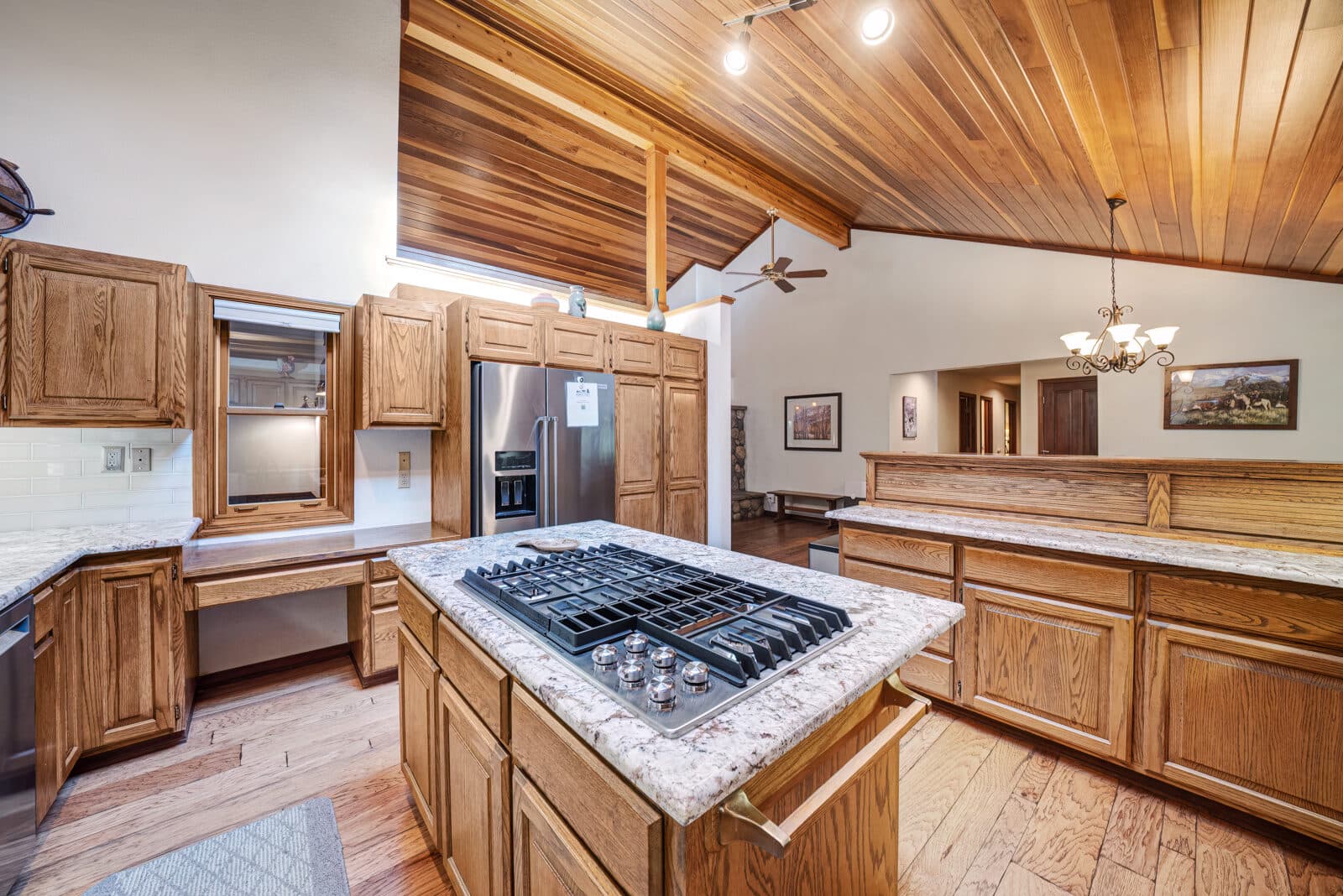 Fully equipped kitchen with wood cabinets and modern appliances at Plumas Pines vacation rental
