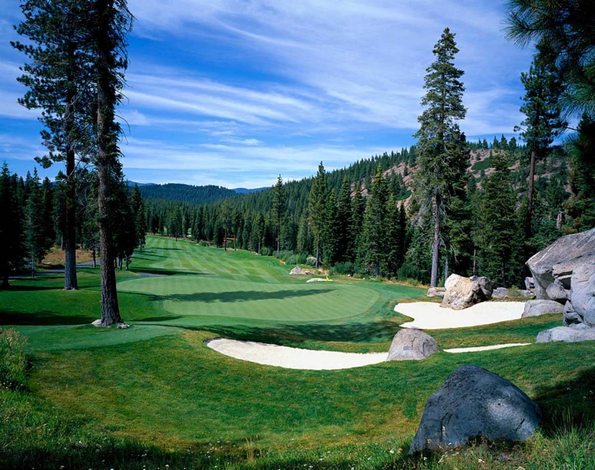 Hole 12 at Coyote Moon Golf Course framed by pine trees Hole 12 at Coyote Moon Golf Course framed by pine trees