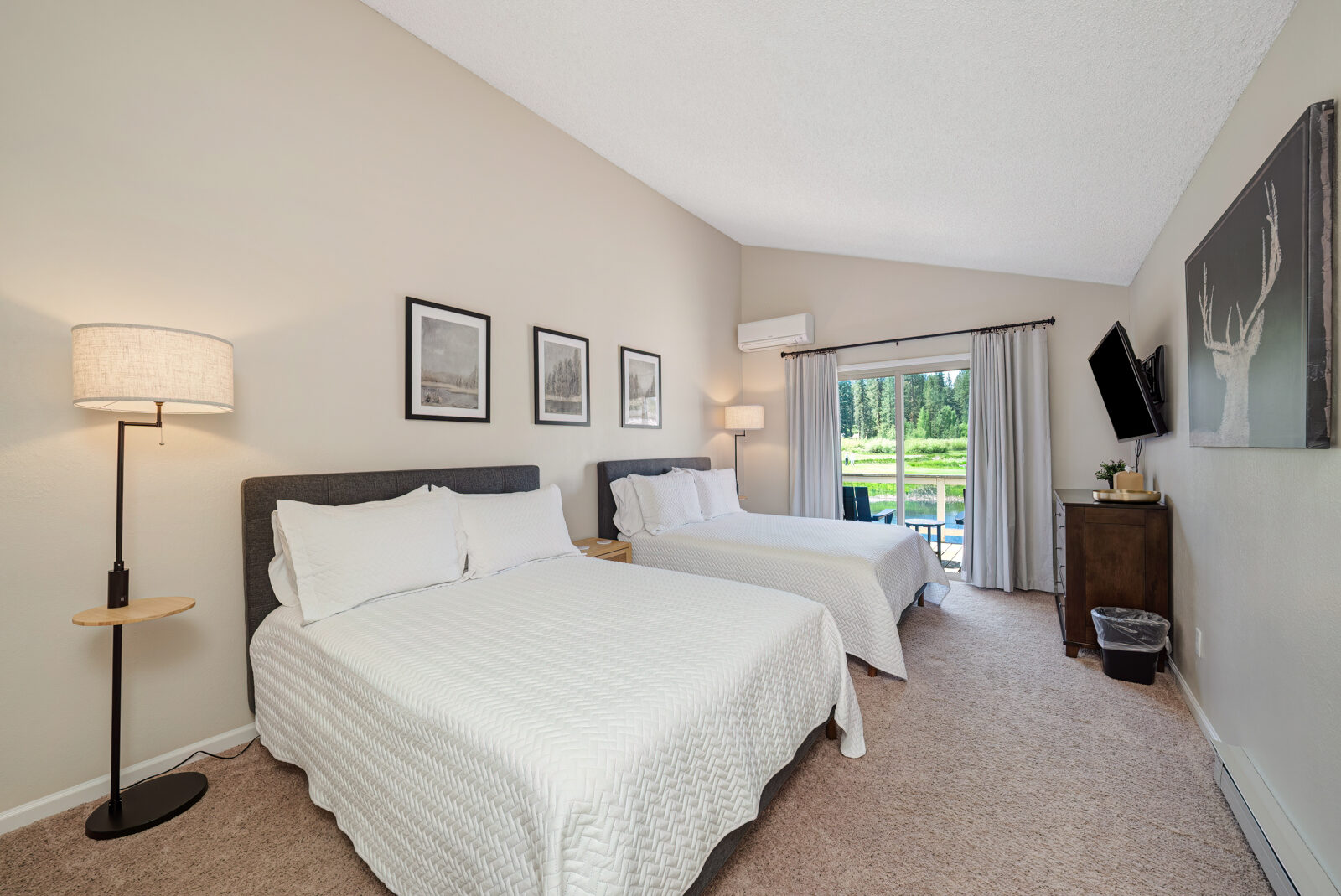 Bedroom with two beds and golf course views at Plumas Pines townhome in Graeagle CA